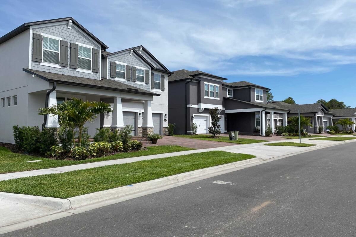 angled photo of four homes along a street